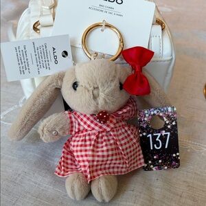137,Aldo Hope Berry beige Bunny Bag Charm with Red Checkered Dress